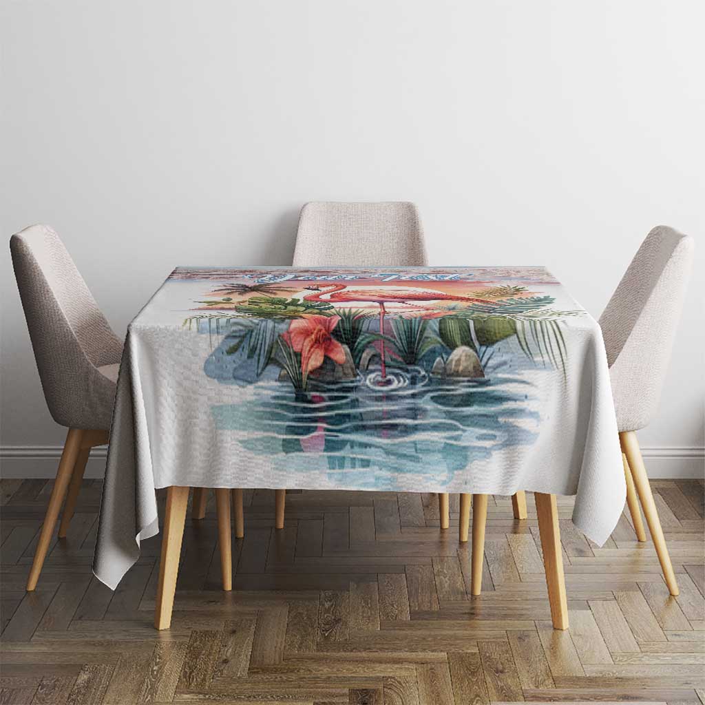 Tropical tablecloth with flamingo and palm leaves on a dining table with chairs