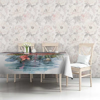 Flamingo and palm-leaf tablecloth on dining table with chairs
