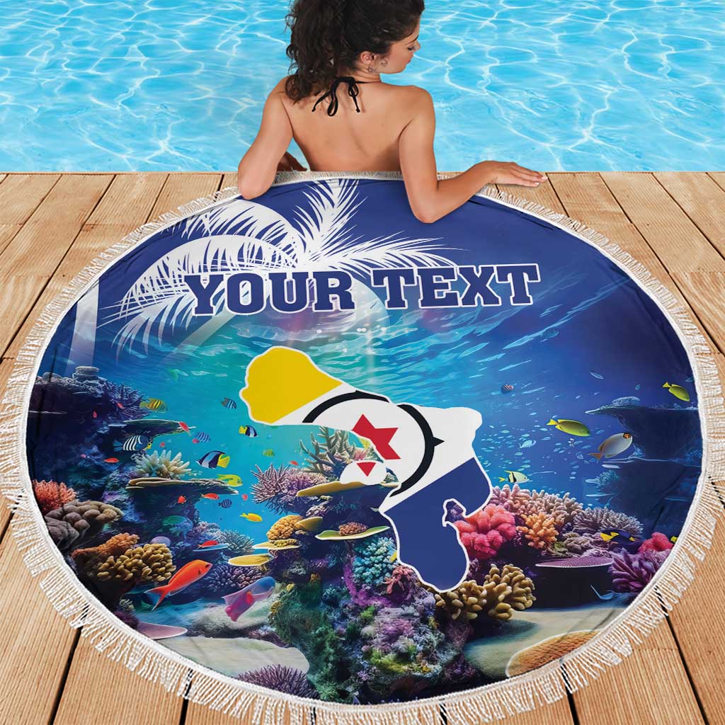 Round blue beach blanket with coral and fish artwork, 'YOUR TEXT' text, white fringe edge