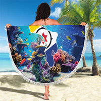 Round blue coral-fish beach blanket with 'YOUR TEXT' print and white fringe, held outdoors