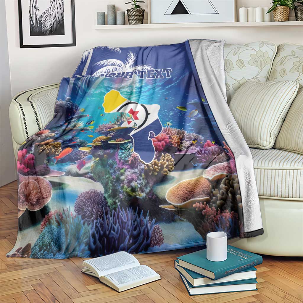 Blue coral reef blanket draped over couch, fish and corals with 'YOUR TEXT' print