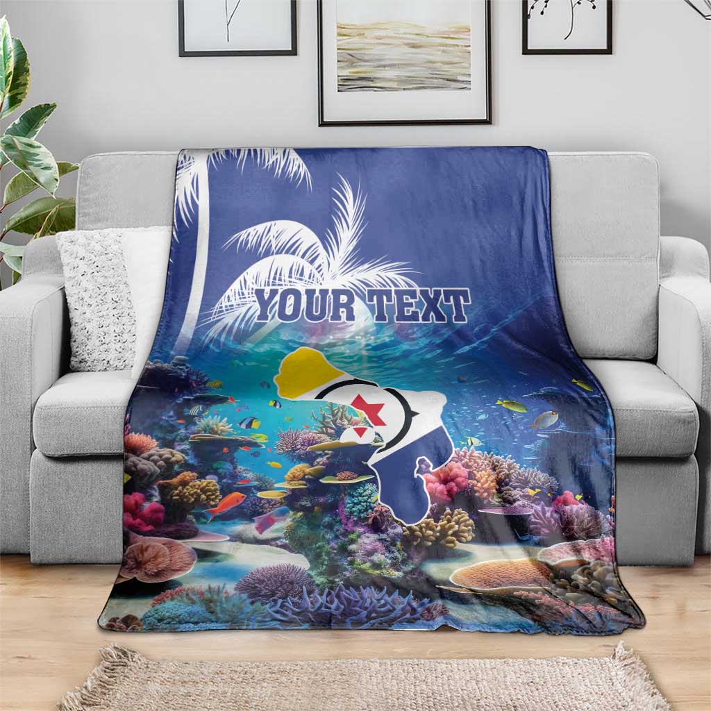 Blue coral reef blanket over gray sofa, fish and corals with 'YOUR TEXT' print