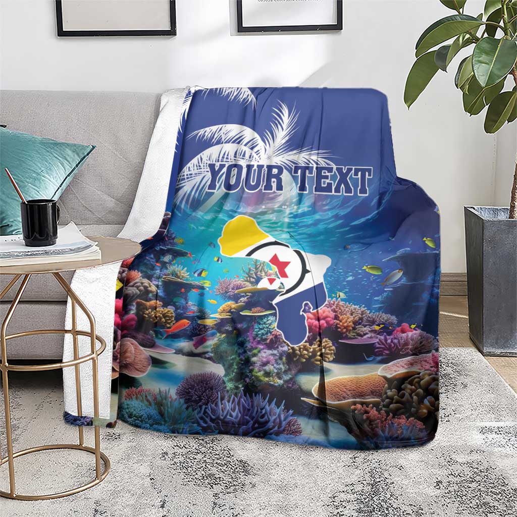 Blue coral reef blanket on gray sofa, fish and corals with 'YOUR TEXT' print