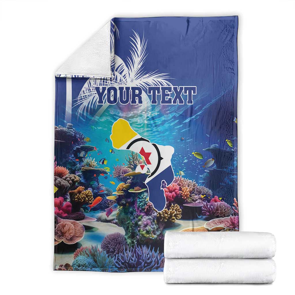 Blue coral reef blanket with fish and corals, 'YOUR TEXT' print; folded stack included