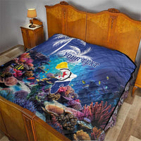 Blue personalized coral reef quilt with sea fish and custom text on a wooden bed frame