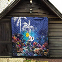 Blue personalized coral reef quilt with sea fish, custom text, hung indoors for display