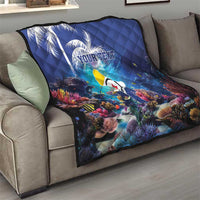 Blue personalized coral reef quilt with sea fish and custom text, draped on a sofa