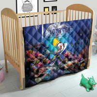 Blue personalized coral reef quilt with sea fish design and custom text, on a child bed