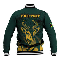 Green baseball jacket back with gold springbok graphic and “YOUR TEXT” print