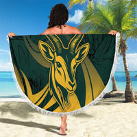 Green round beach blanket with fringe edge, gold springbok emblem and leafy pattern, custom text