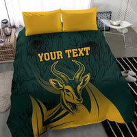 Green duvet cover with springbok graphic and two yellow pillows, “YOUR TEXT”