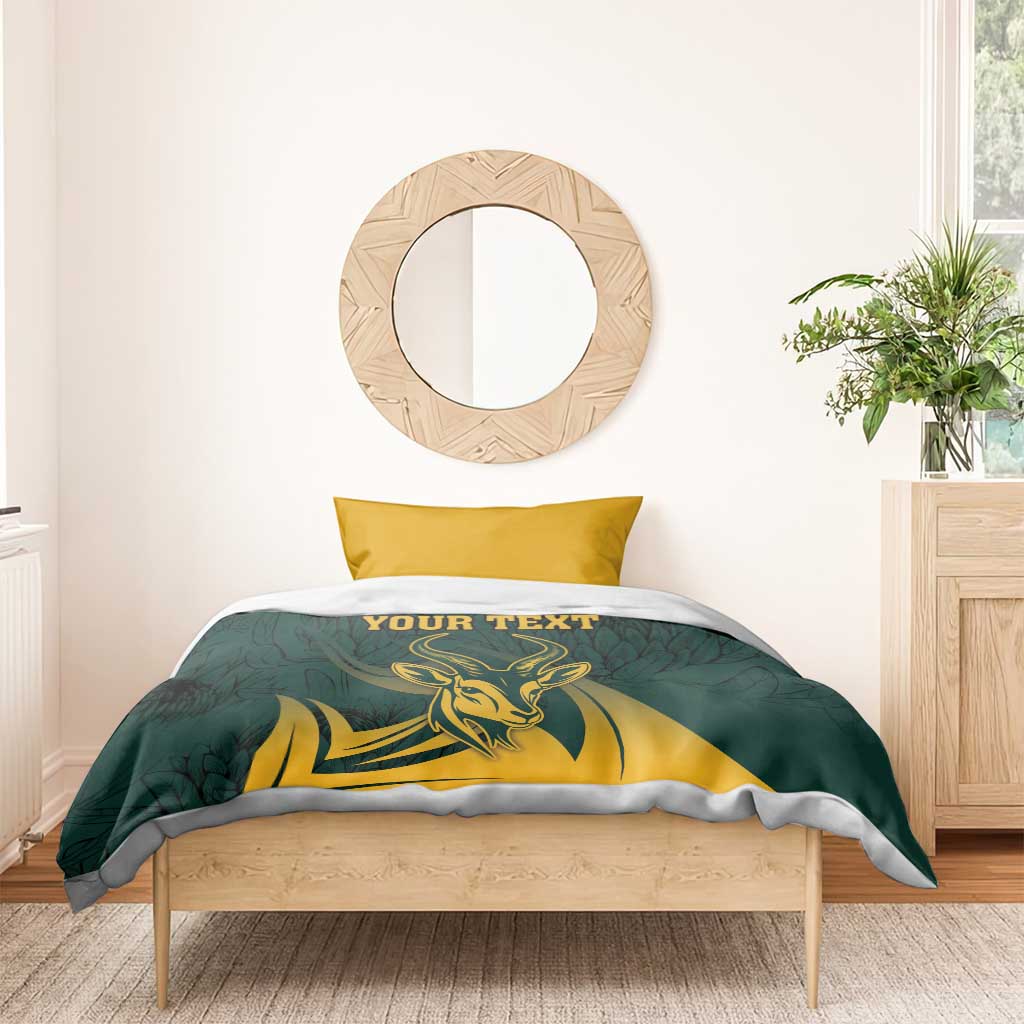 Green springbok-themed duvet cover with “YOUR TEXT” and two yellow pillows