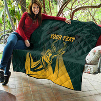 Green quilt draped on sofa with yellow springbok graphic and customizable text