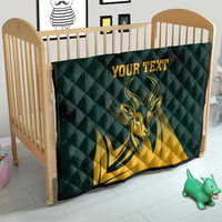 Green quilt fitted in baby bed with yellow springbok graphic and text area