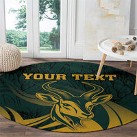 Round green carpet with gold springbok artwork, leafy background, and "YOUR TEXT"