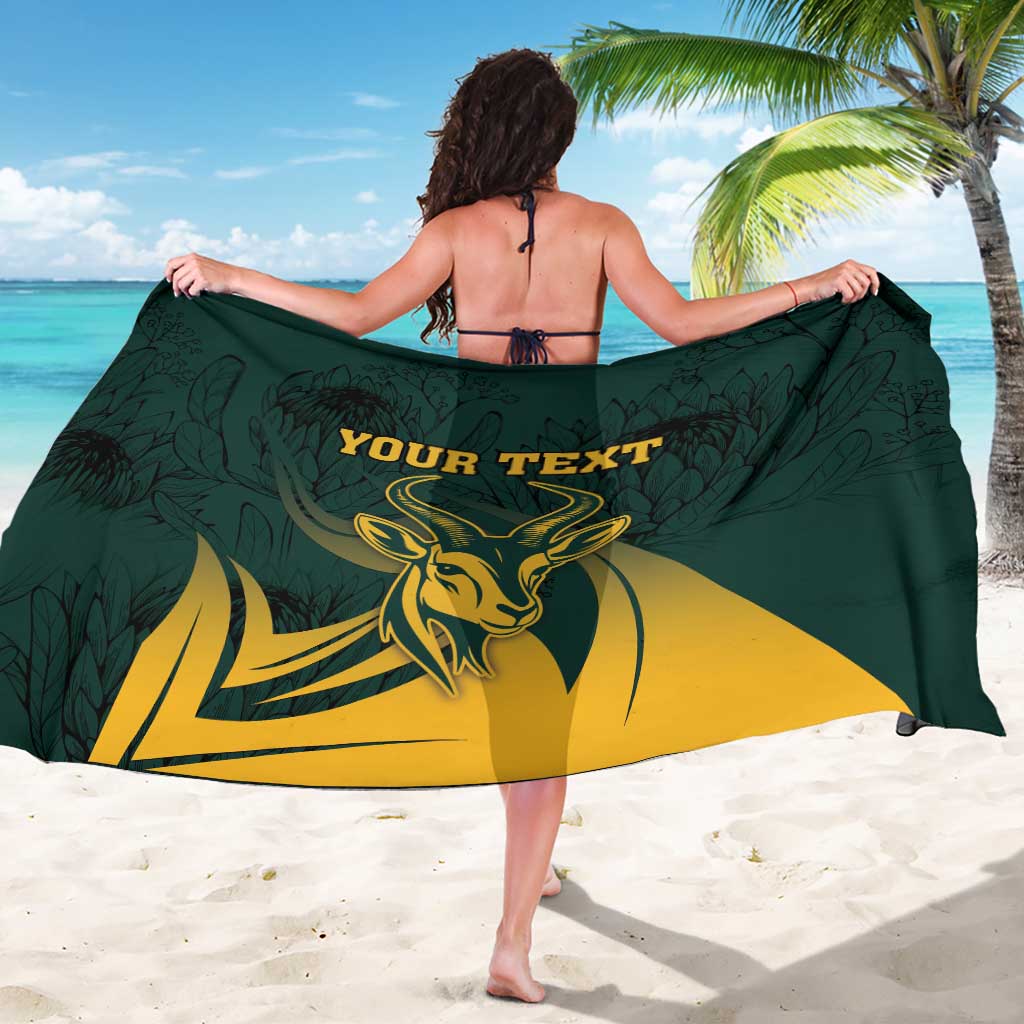 Green sarong worn as wrap with springbok flag print and 'YOUR TEXT' text