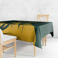 Green and gold tablecloth with antelope motif and dark leaf design, draped