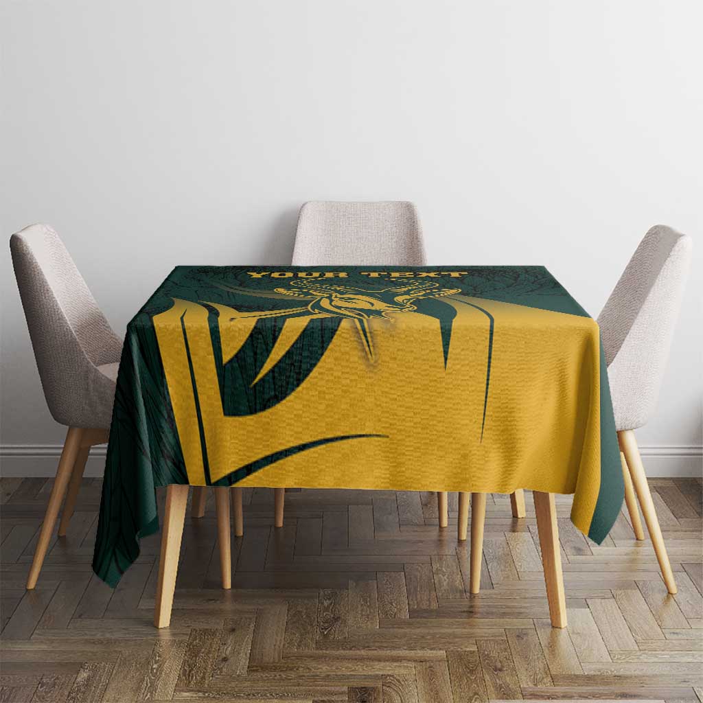Green tablecloth with gold antelope illustration and dark botanical pattern