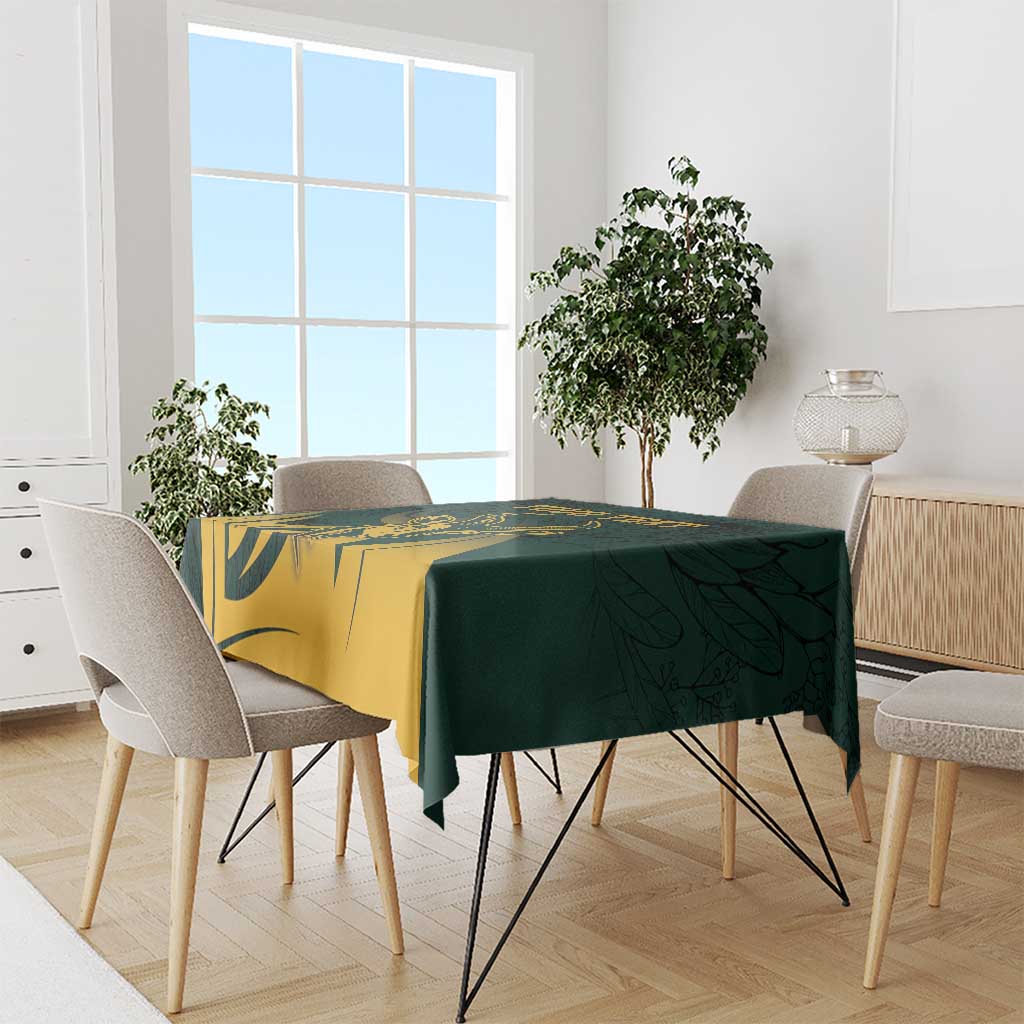 Green and gold tablecloth with bold antelope graphic and leaf print
