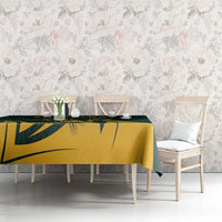 Green tablecloth with gold antelope motif and dark leaf pattern