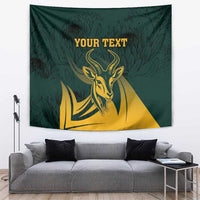 Green springbok tapestry with gold head graphic, feathered leaf pattern, centered text