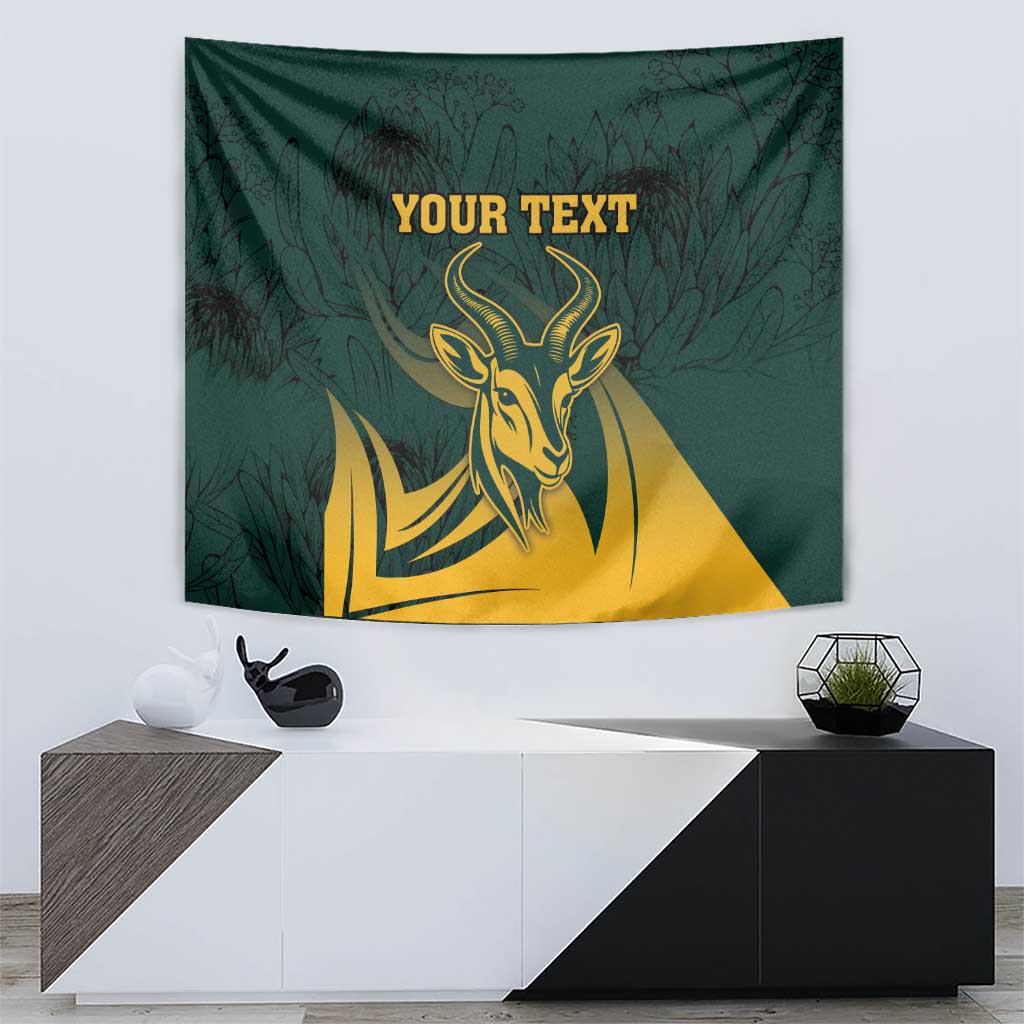 Green tapestry featuring gold springbok head, dark leaves, and centered editable text