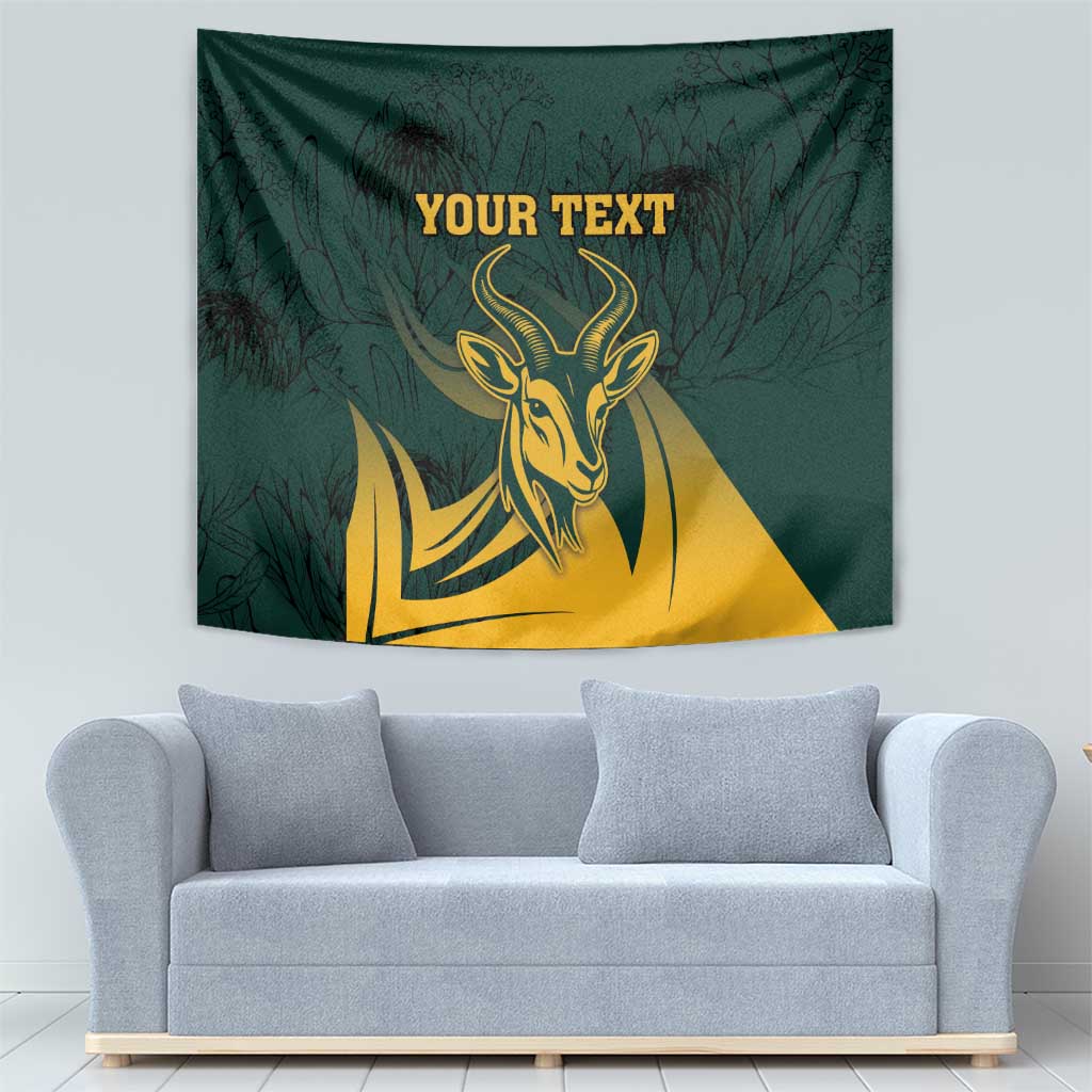 Green springbok wall tapestry with gold head emblem and leaf background, centered text