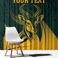 Close-up green window curtain with gold springbok head and personalized text lettering