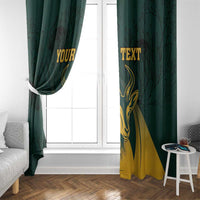 Green window curtain with gold springbok graphic and personalized text, partially open