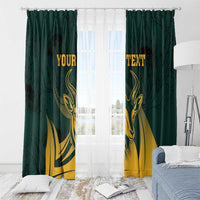 Green window curtains with gold springbok print and personalized text, hanging over window