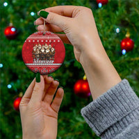 Red ceramic round ornament held in hand, Yule lads group and Nordic pattern