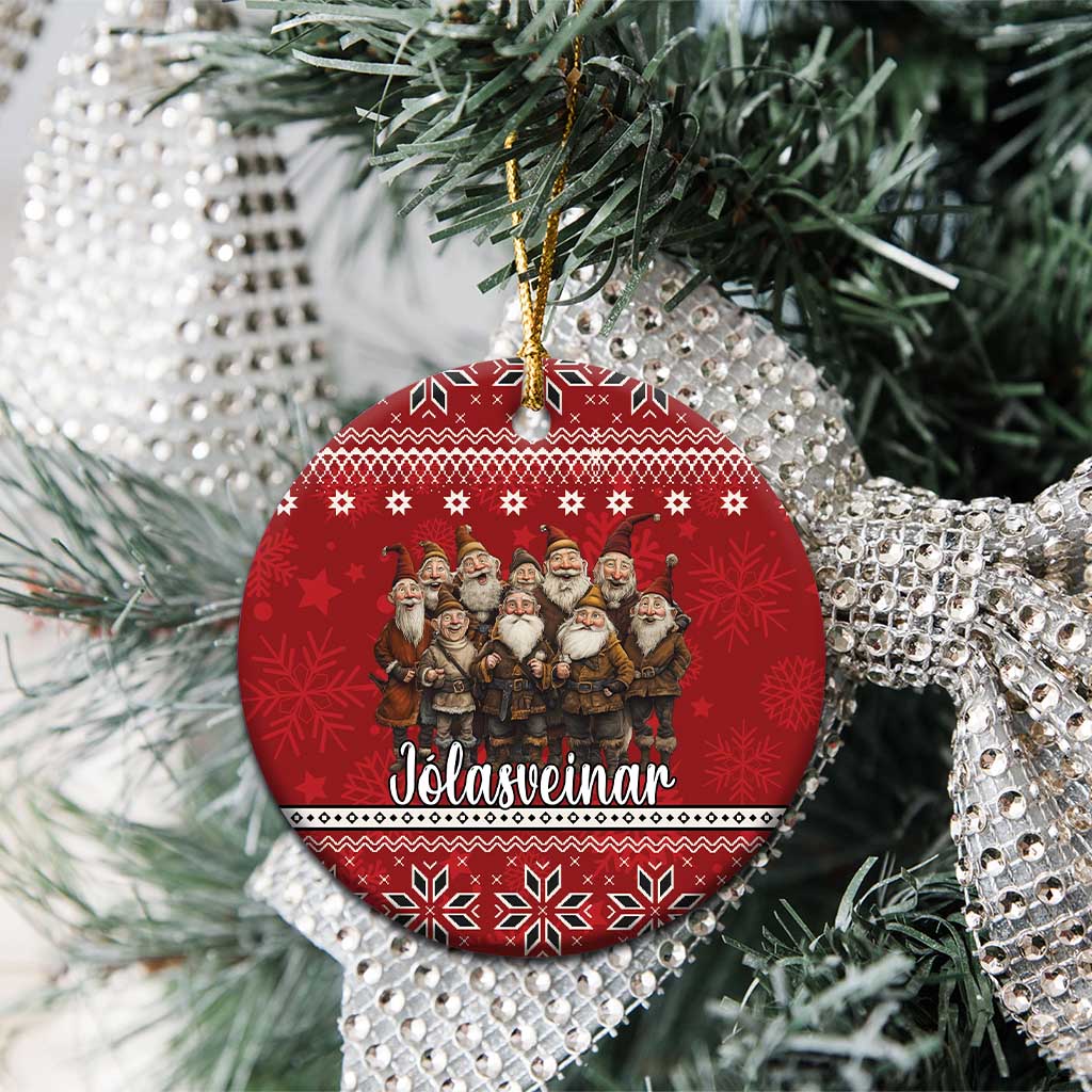 Red ceramic round ornament with Yule lads group design on a Christmas tree branch