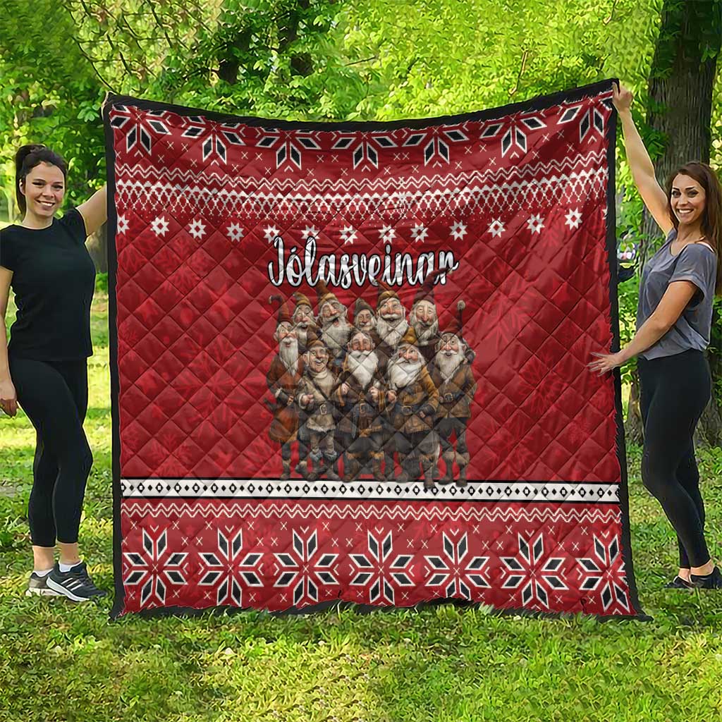Red quilt with Nordic pattern top and bottom borders, featuring gnome group and text