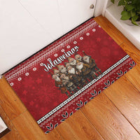 Red rubber doormat angled view with Icelandic Christmas gnomes and patterned edge