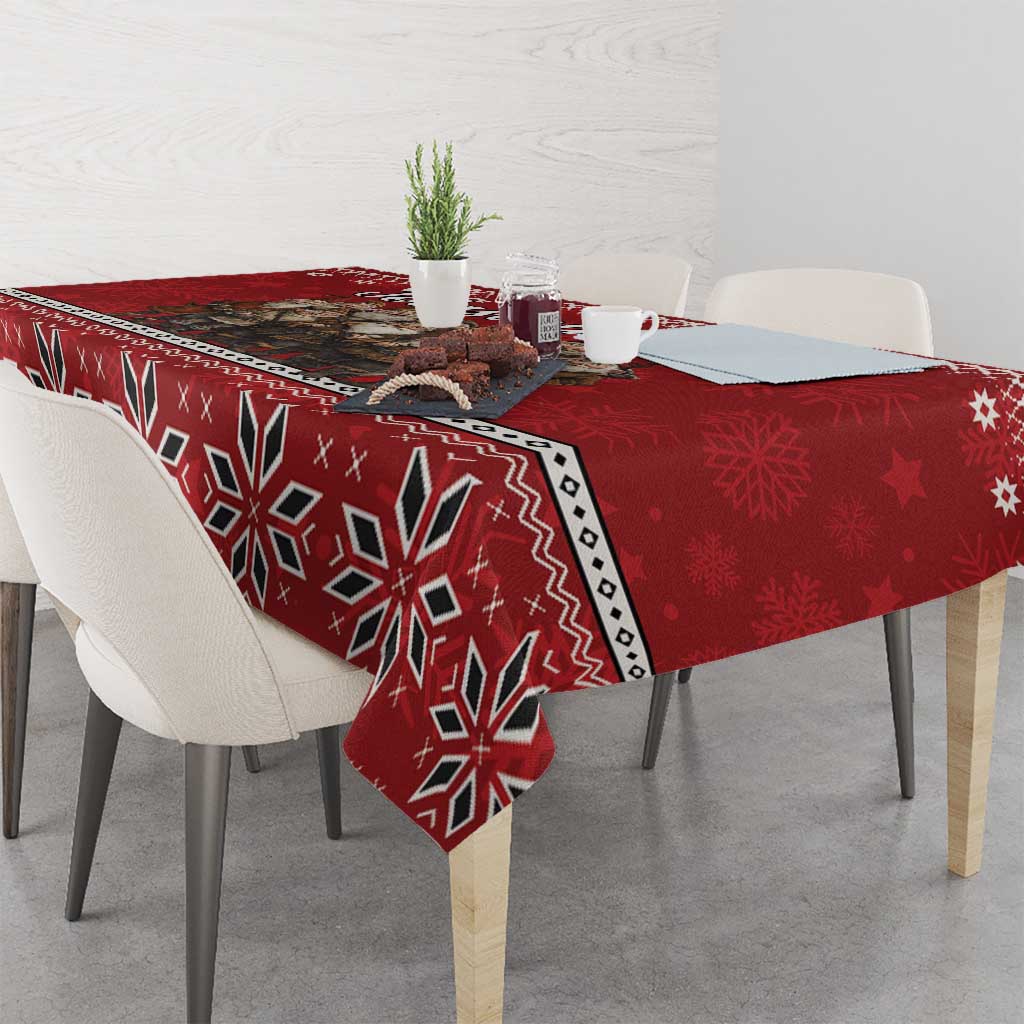 Red tablecloth with bold geometric snowflake pattern and white decorative edge