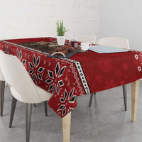 Red tablecloth with bold geometric snowflake pattern and white decorative edge