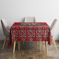Red geometric snowflake tablecloth on table with four beige dining chairs