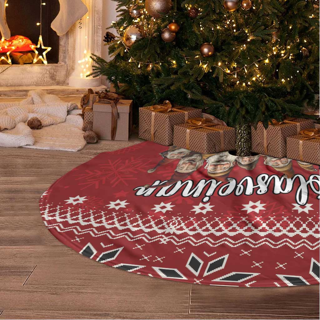 Red Christmas tree skirt with round shape, Nordic elf graphic, and white fringe edge