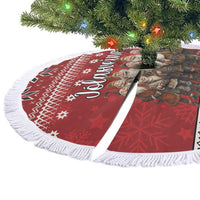 Red circular tree skirt with white fringe and Nordic star/snowflake graphic