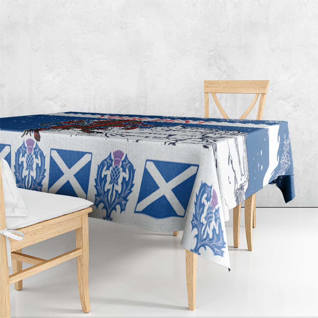 Blue holiday tablecloth on table and bench, featuring crest and white X pattern