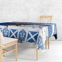 Blue holiday tablecloth on table and bench, featuring crest and white X pattern