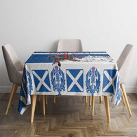 Blue holiday tablecloth on dining table with crest and white X motifs
