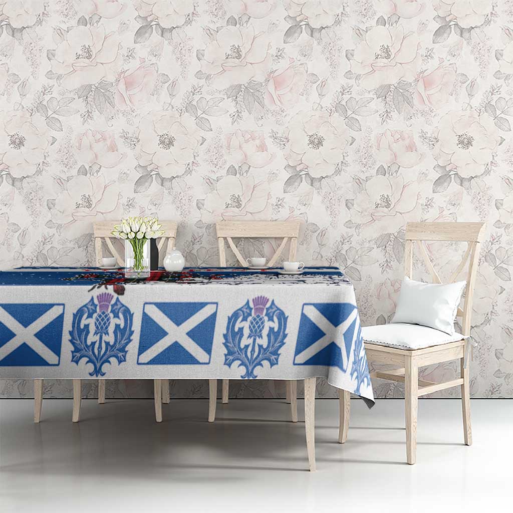 Blue holiday tablecloth on dining table with blue crest and white X motifs