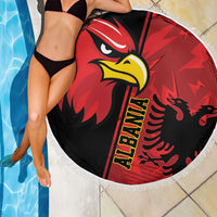 Round Albania eagle beach blanket in red and black with white fringed edge