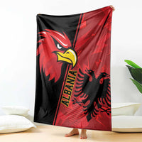 Red and black eagle emblem grunge blanket with bold diagonal stripe design, corner view