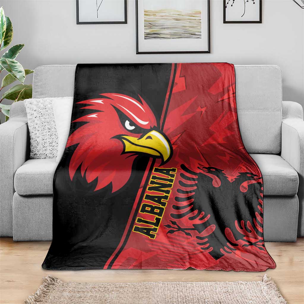 Red and black eagle emblem grunge pattern blanket spread on a gray sofa