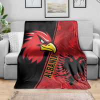 Red and black eagle emblem grunge pattern blanket spread on a gray sofa