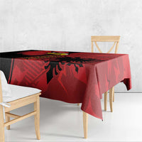Red tablecloth with eagle emblem grunge design, hanging over bench edge