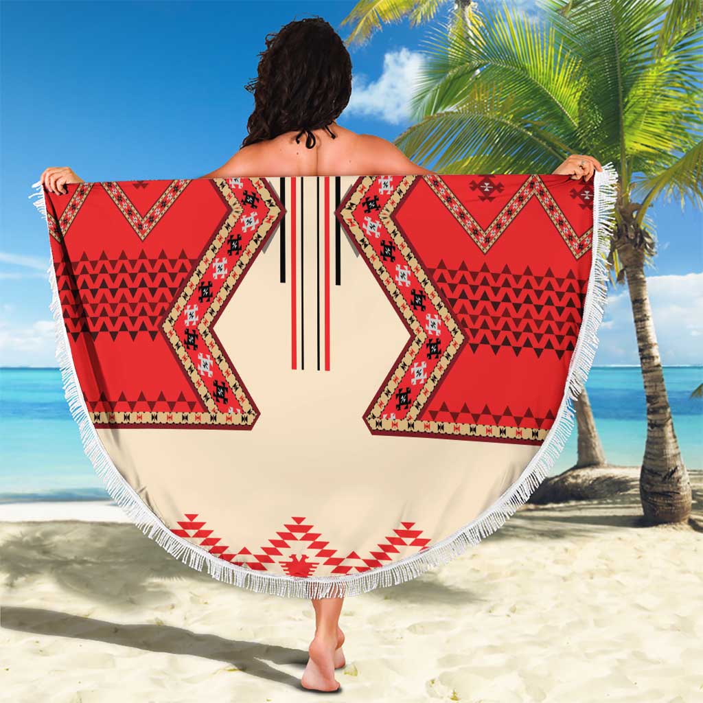 Round beach blanket held out, beige with red folk geometric pattern and white fringe
