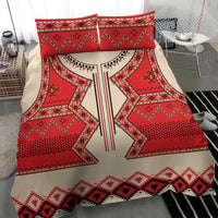 Bedding set close-up: red and cream folk pattern duvet with two red pillow shams